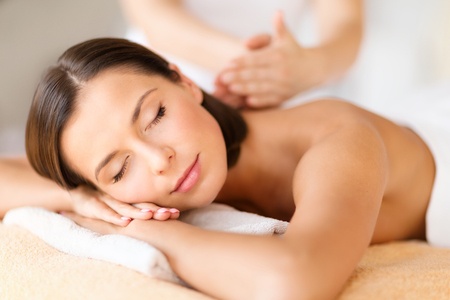 47304411 - health, beauty, resort and relaxation concept - beautiful woman with closed eyes in spa salon getting massage